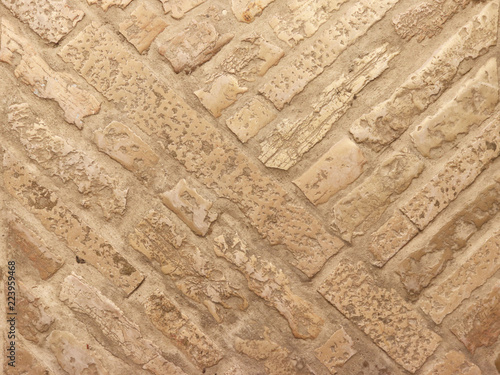 Masonry on the floor of marble brick in warm tones. Texture and background for design and decoration. Natural building material. The work of a mason. Ancient solid buildings. historical technologies 