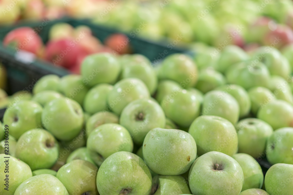 Green apples in a box in the store. green apples in boxes on market shelves. grocery shopping concept. healthy food. Green apples in a box in the store. green apples in boxes on market shelves. grocery shopping concept. healthy food.