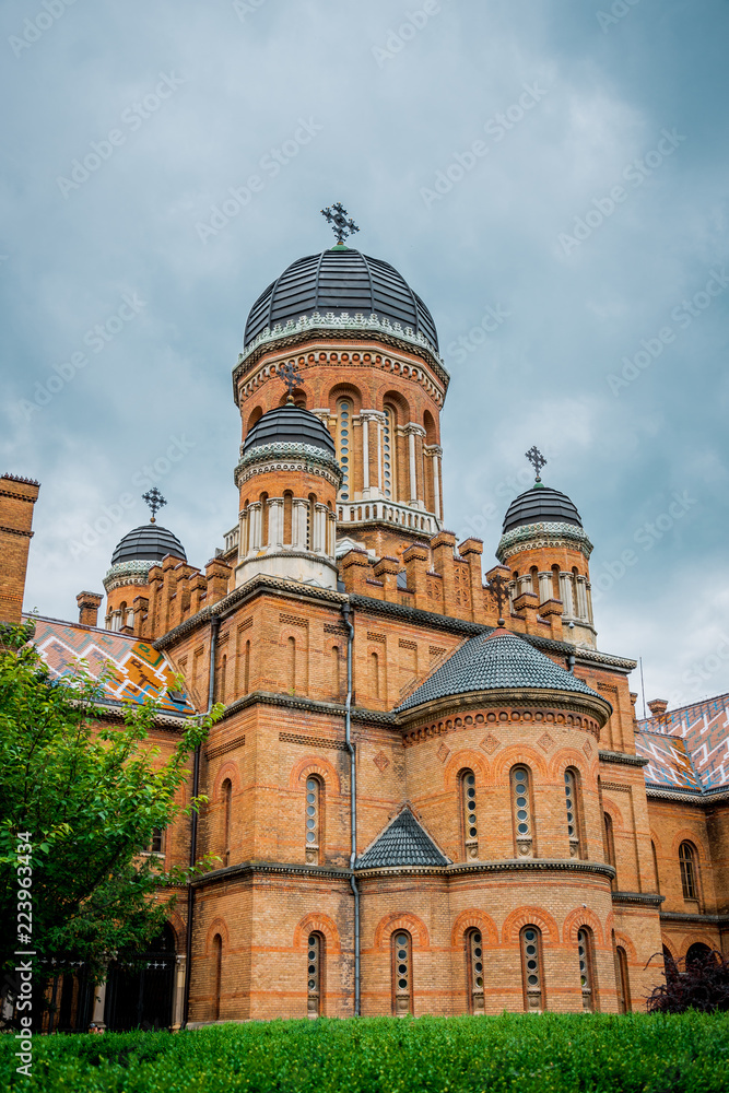 Ancient orthodox church and a summer flowering garden