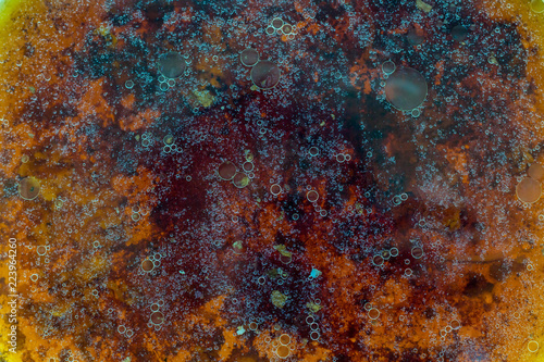 Stains of fat on the surface of water abstraction. Creative rough textured background