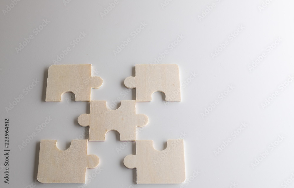Last piece of wooden jigsaw is almost in place for business solution concept Last piece of wooden jigsaw is almost in place for business solution concept