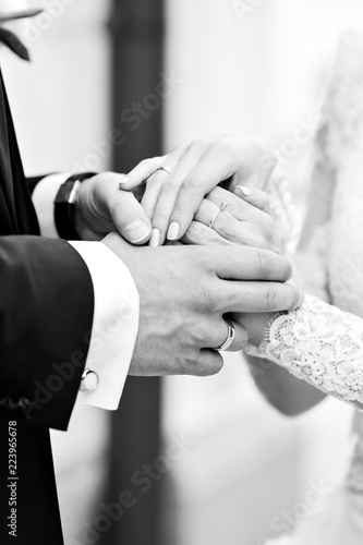 Hands of the happy groom and the bride at a wedding ceremony