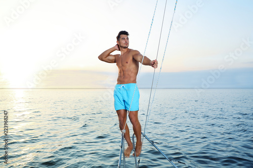 Young wealthy man on yacht enjoying sunset