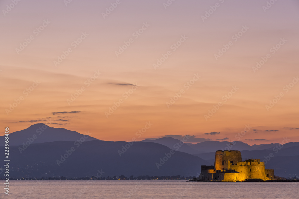 Evening view of Bourtzi fortress with mountains in the background in Nafplio