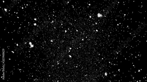 Isolated snow falling on black background photo