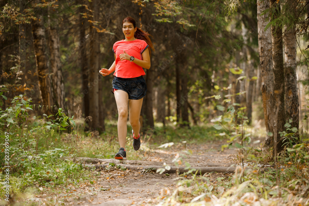 Photo of sports girl running through park Photo of sports girl running through park