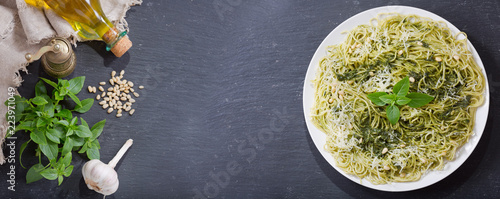 plate of pasta with pesto sauce with ingredients for cooking