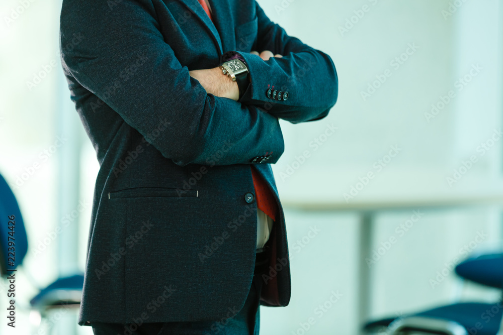 Portrait of happy businessman with arms crossed standing in office Portrait of happy businessman with arms crossed standing in office