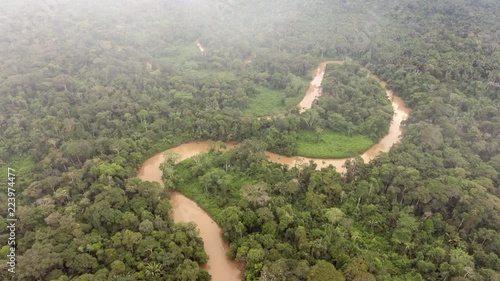 Aerial view of the Rio Shiripuno in the Ecuadorian Amazon at dawn with mist blowing over the rainforest canopy. photo