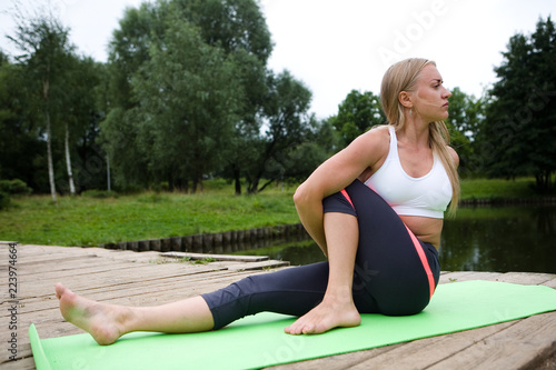 Beautiful slender girl performs a yoga pose.