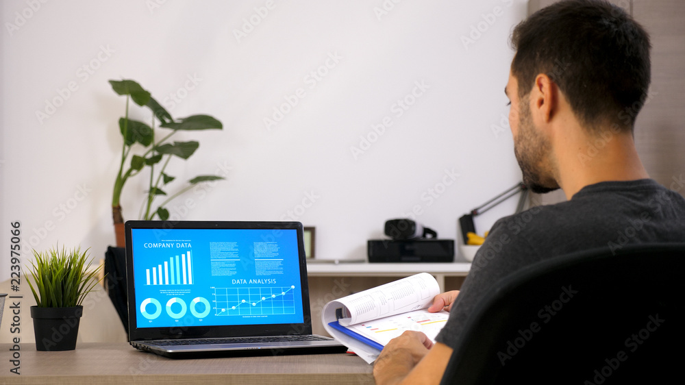Business man working at office with laptop. Document on his desk. Motivated man Business man working at office with laptop. Document on his desk. Motivated man