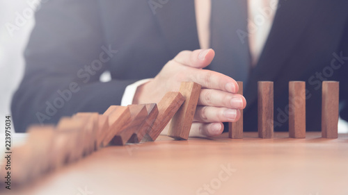 Fotografía Problem Solving, Close up hand of businessman stopping falling blocks on table
