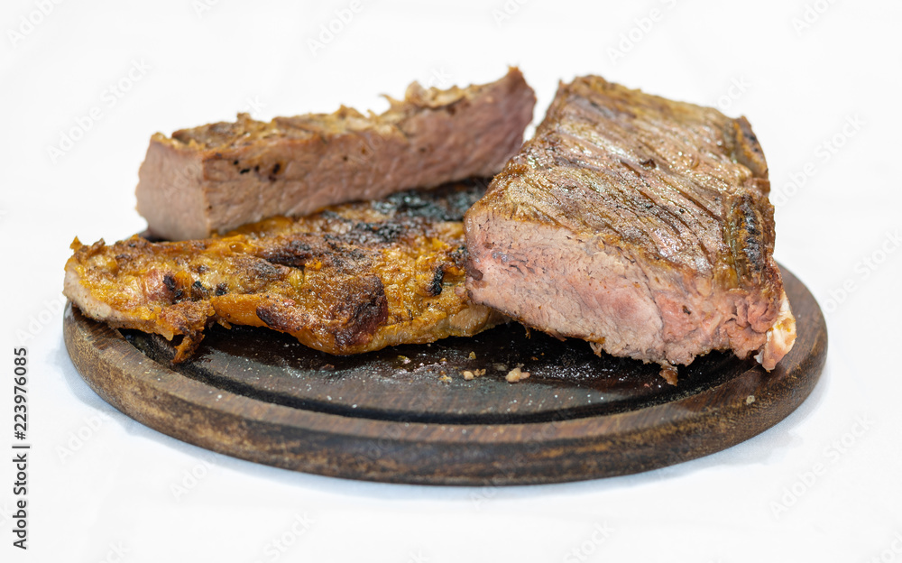 Delicious beef steak on wooden table, close-up Delicious beef steak on wooden table, close-up