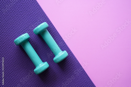 Fototapeta Naklejka Na Ścianę i Meble -  dumbbell and yoga mat on table, fitness healthy and sport concept