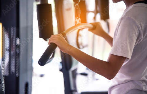 Young women exercise in a professional gym with a selection of exercise equipment.