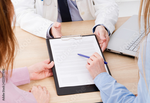 doctor discusses with patients medical contract at the clinic, medical insurance photo