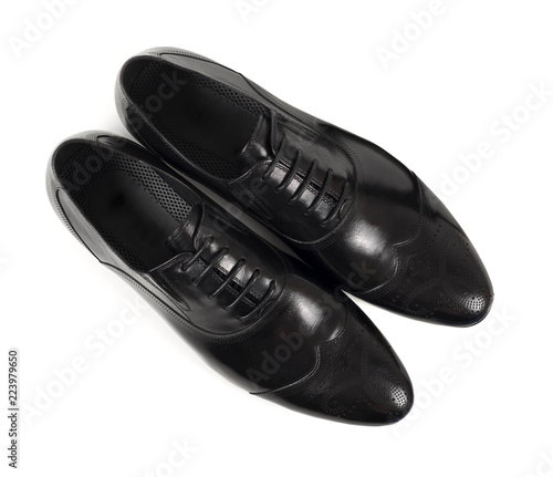 Top view of classic black leather shoes on white