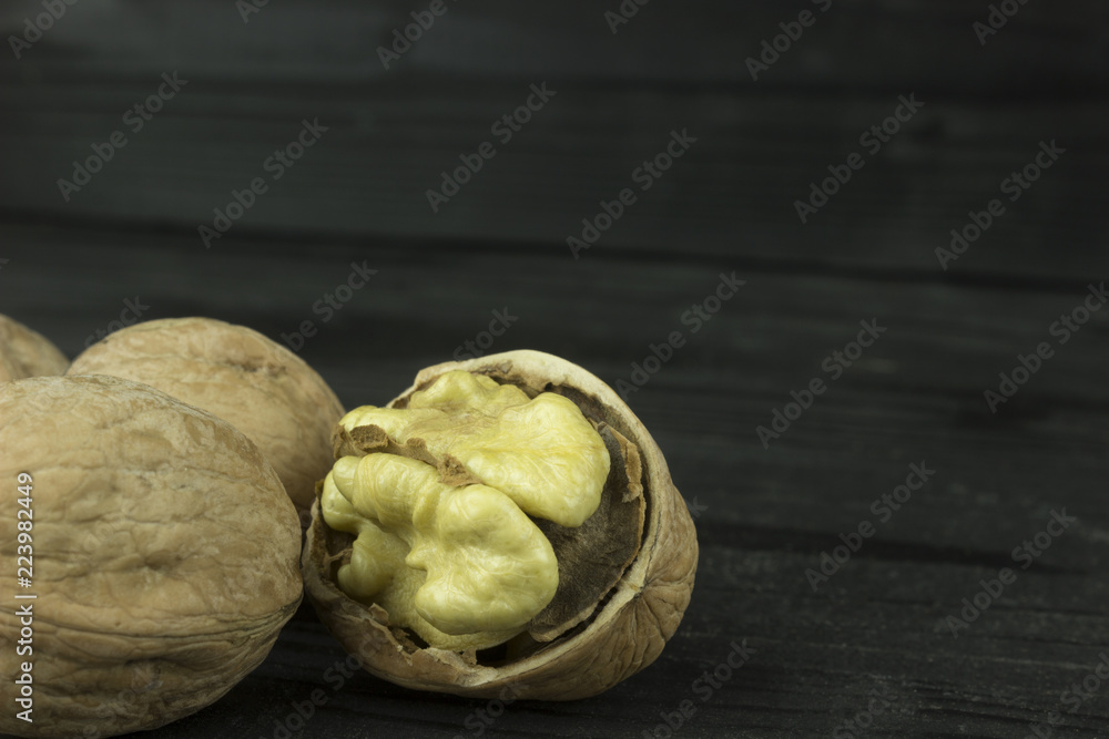 walnut walnut on a dark wooden table walnut walnut on a dark wooden table
