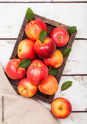 Pink lady royal gala red organic healthy apples in vintage box on wooden background.