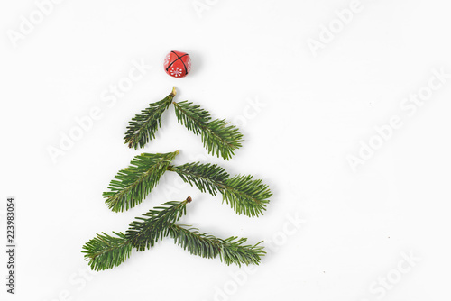 Christmas tree shape made of fir-tree branches isolated on white background. Free copy space. photo