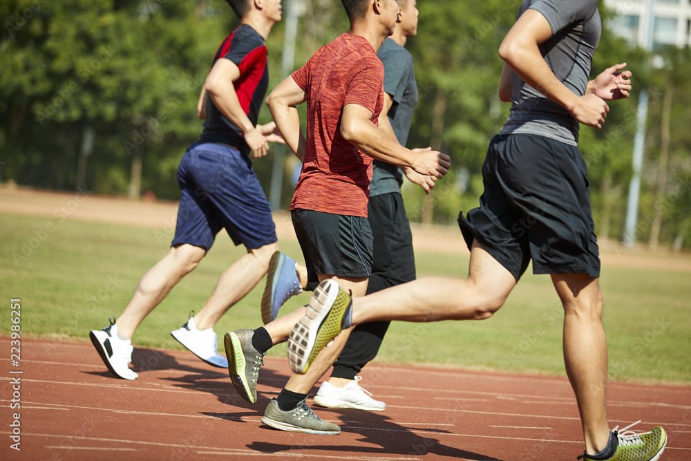 Fototapeta premium asian young adults running on track