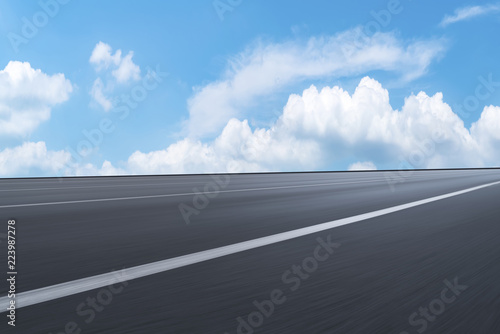 Road pavement under blue sky and white clouds