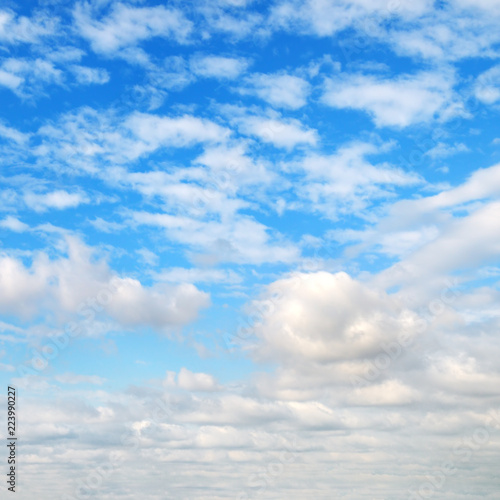 Cumulus clouds in the blue sky.