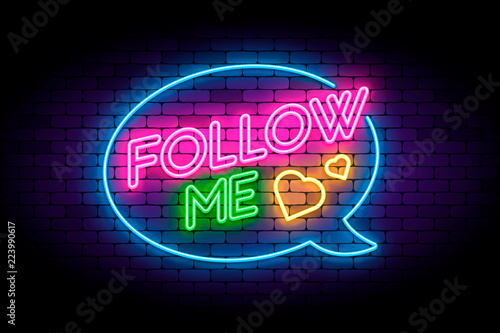 Follow me neon sign on the brick wall with hearts and speech bub