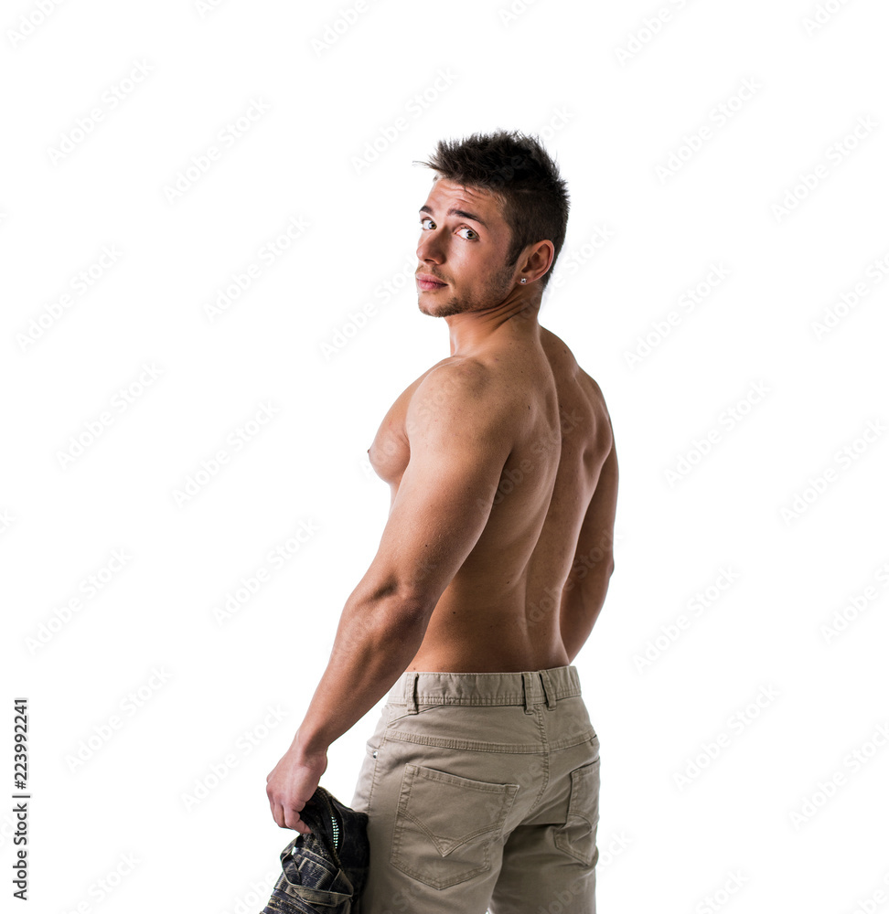 Fototapeta premium Cute muscular ripped young bodybuilder turning to look at camera. Isolated on white background in studio
