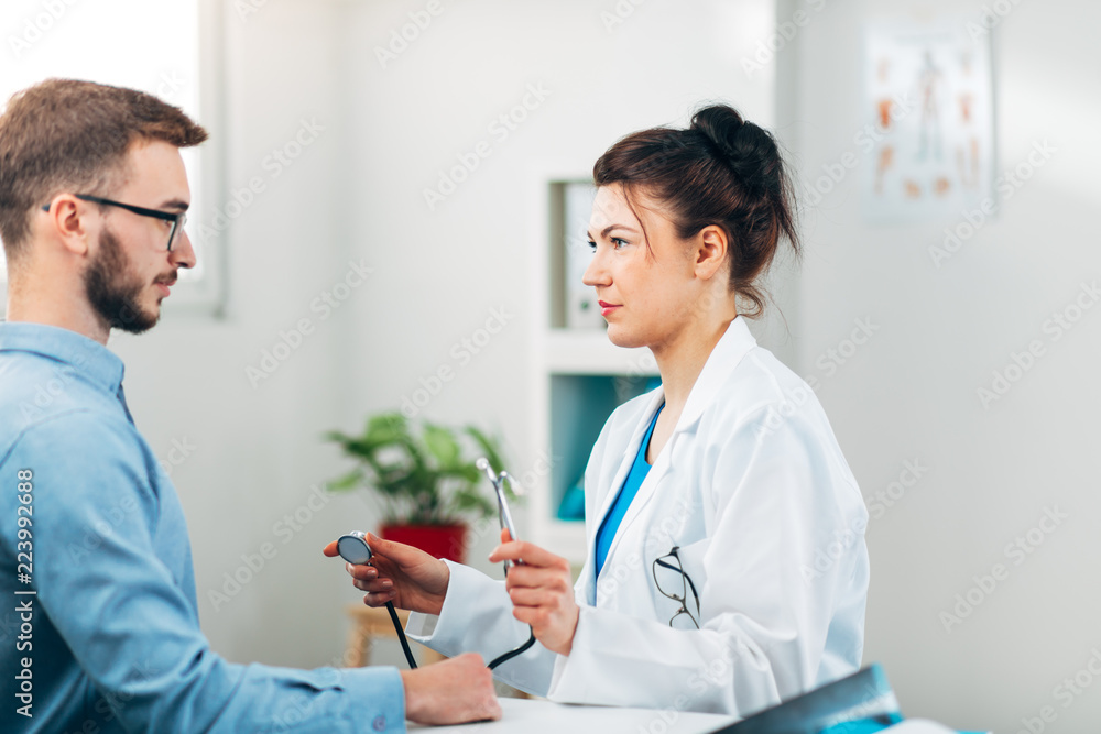 Woman Doctor talking to Patient at her Medical Office Woman Doctor talking to Patient at her Medical Office