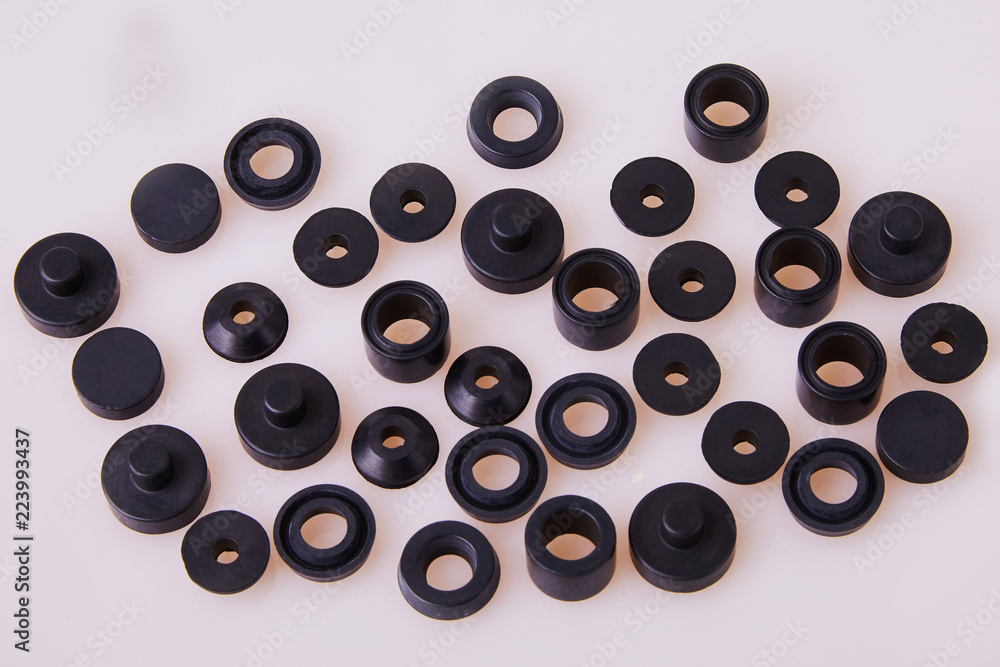 Black hydraulic and pneumatic o-ring seals of different sizes scattered a white background. Rubber rings. Sealing gaskets for hydraulic joints. Rubber sealing rings for plumbing. Top view Black hydraulic and pneumatic o-ring seals of different sizes scattered a white background. Rubber rings. Sealing gaskets for hydraulic joints. Rubber sealing rings for plumbing. Top view