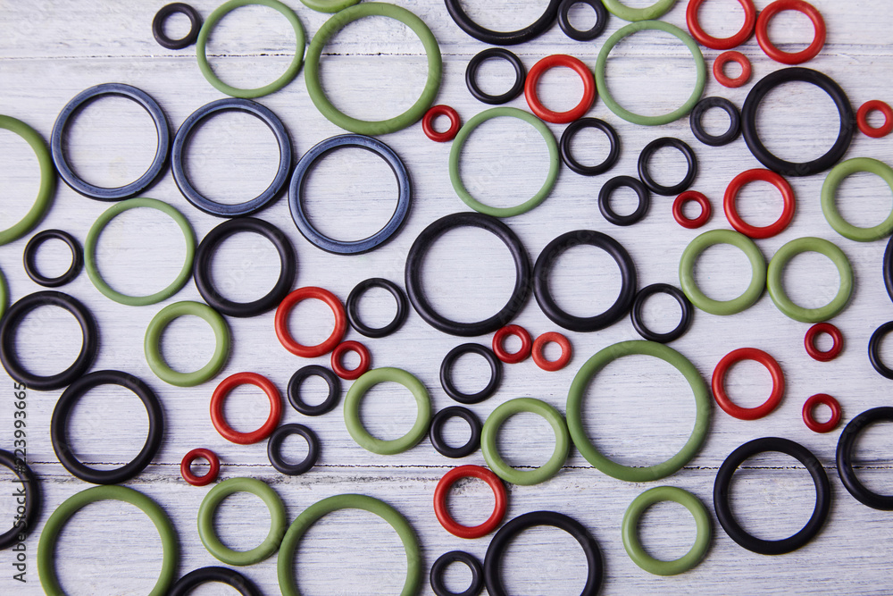 Black, red and gre hydraulic and pneumatic o ring seals of different sizes scattered a white background. Rubber rings. Sealing gaskets for hydraulic joints. Rubber sealing rings for plumbing. Top view Black, red and gre hydraulic and pneumatic o ring seals of different sizes scattered a white background. Rubber rings. Sealing gaskets for hydraulic joints. Rubber sealing rings for plumbing. Top view