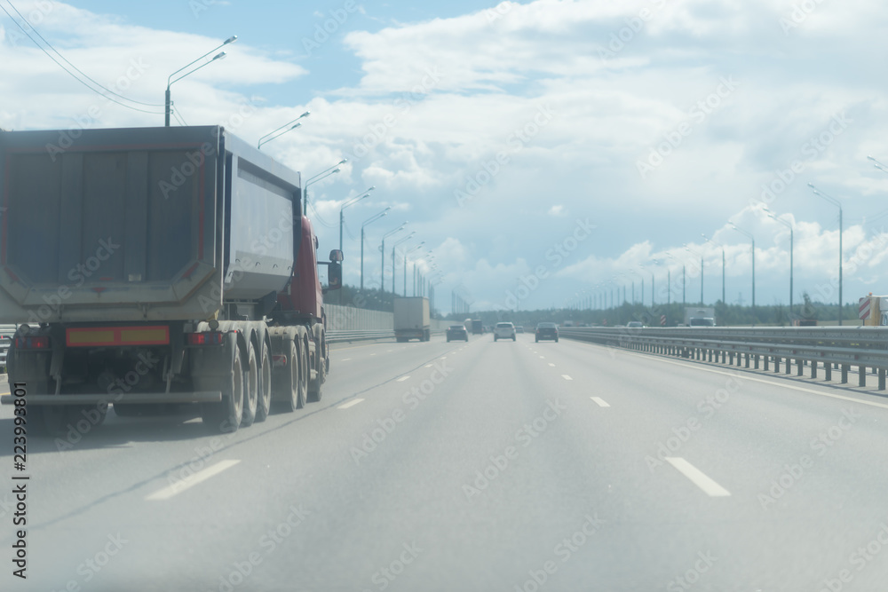 A lorry with tipping trailer in motion on the motorway.