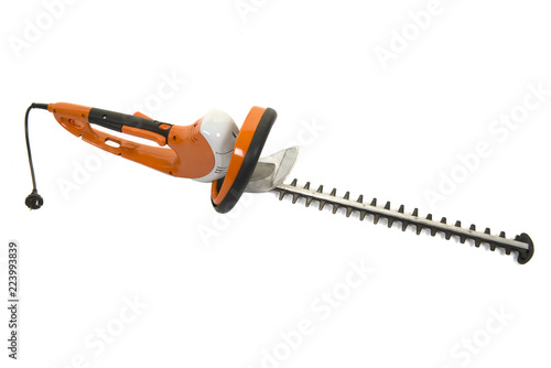 Fototapeta Naklejka Na Ścianę i Meble -  Orange used electric hedge trimmer isolated on a white background