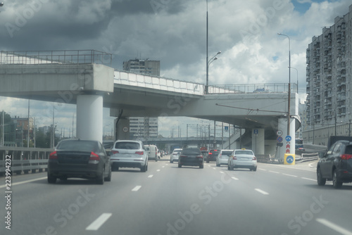 New Riga highway. Elevated roads on cloudy day. City traffic with a lot of cars.