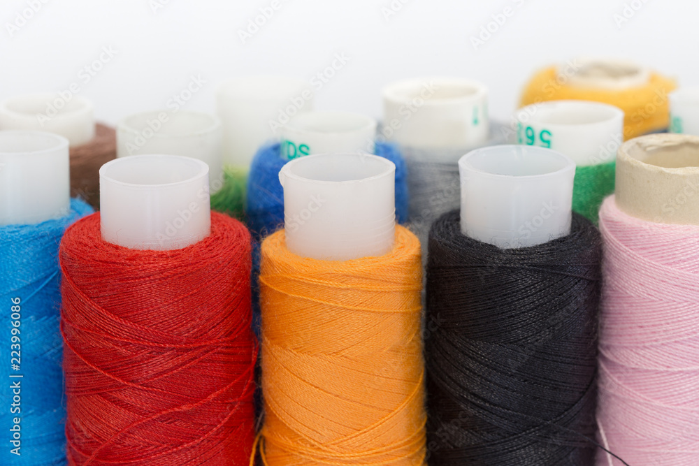 Multi-colored thread on bobbins Multi-colored thread on bobbins