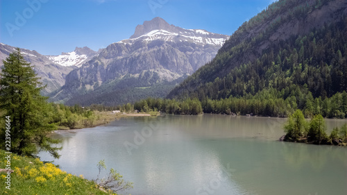 The Lac de Derborence in the canton of Valais, in Switzerland. It is located at 1,450 metres in an isolated valley and is not permanently inhabited. Derborence is completely surrounded by mountains.