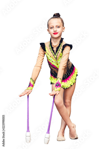Little girl is engaged in rhythmic gymnastics with juggling clubs isolated on white. © Marina Varnava