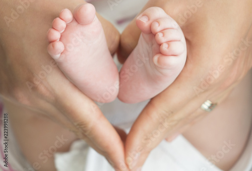 baby feet in mother hands - hearth shape © batuhan toker