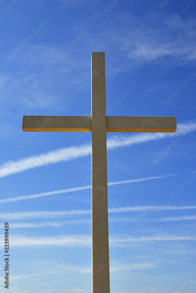 religion wooden cross against the blue sky.