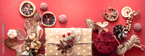 Christmas concept, gift box with decor on red background