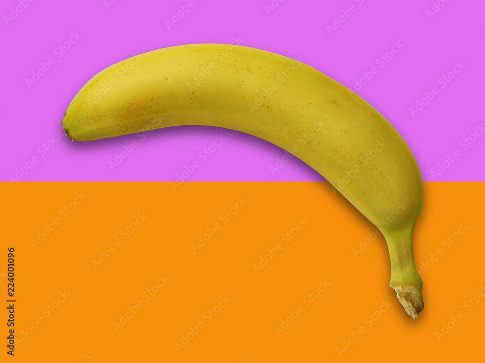 Banana close up isolated on pastel pink and orange backgroud - modern minimalistic art image