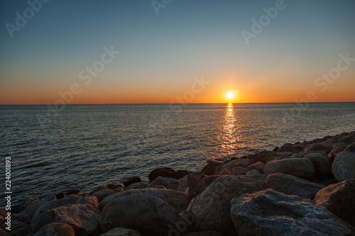 Beautiful sea sunset, the sun sets behind the horizon, a minimalistic landscape