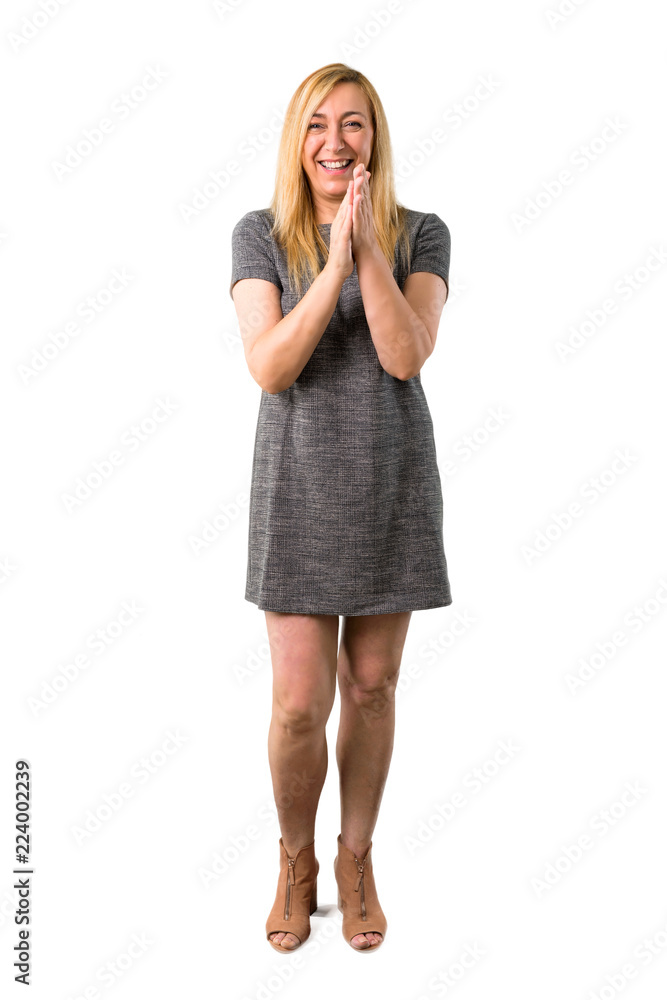 Fototapeta premium Middle age blonde woman with grey dress smiling and applauding on isolated white background