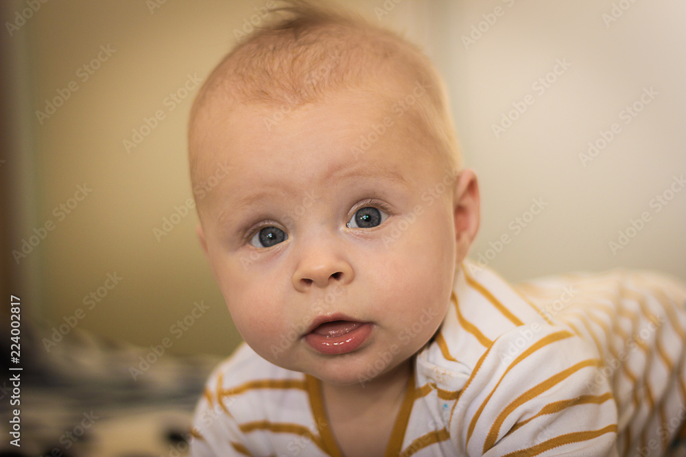 Portrait of a expressive happy baby, holds head up. baby development concept photo, lifestyle Portrait of a expressive happy baby, holds head up. baby development concept photo, lifestyle