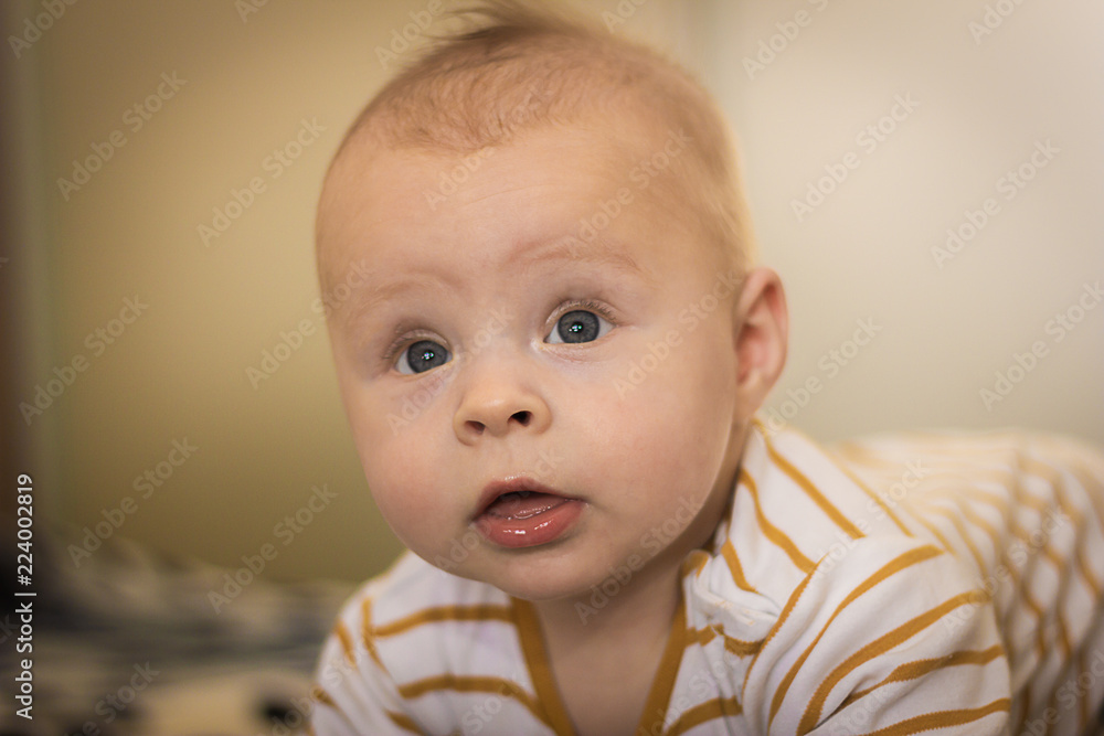 Portrait of a expressive happy baby, holds head up. baby development concept photo, lifestyle Portrait of a expressive happy baby, holds head up. baby development concept photo, lifestyle