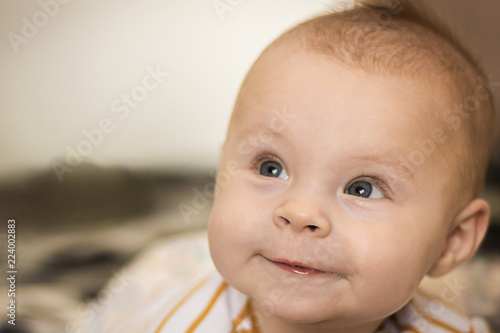 Portrait of a expressive happy baby  holds head up. baby development concept photo  lifestyle