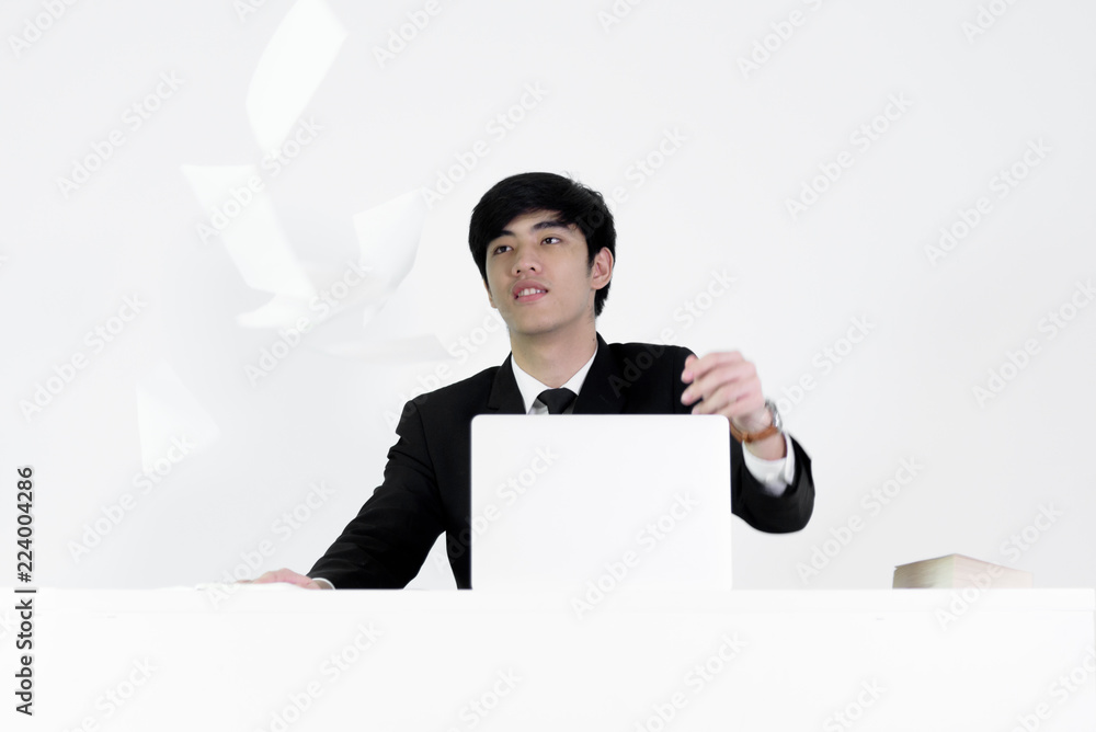 Asian manager businessman sitting at desk throwing papers with feeling angry and upset, isolated on white background. Asian manager businessman sitting at desk throwing papers with feeling angry and upset, isolated on white background.