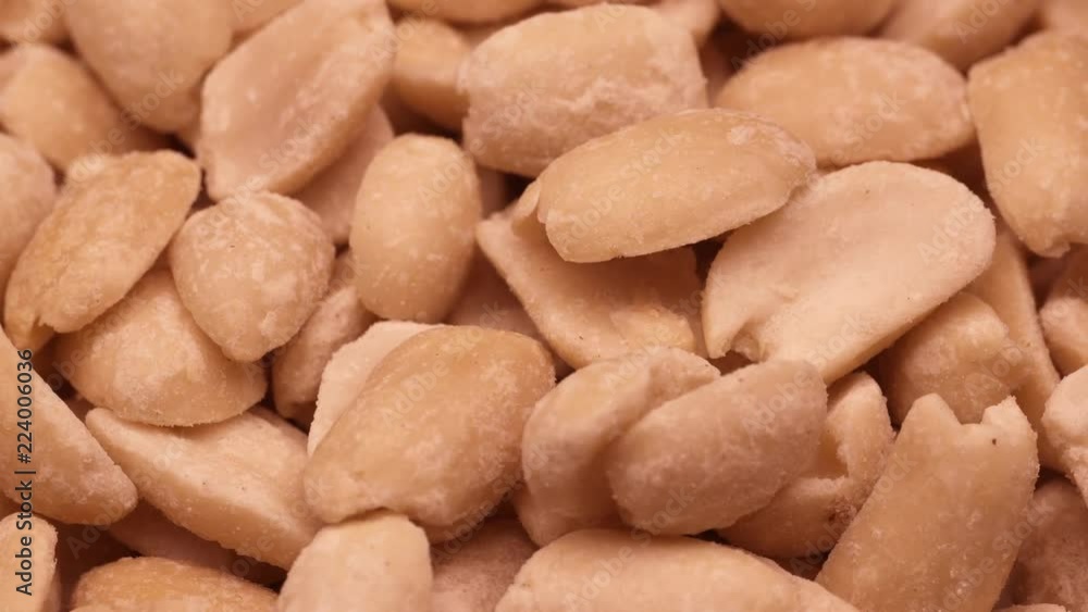 Roasted salted peanuts on a turntable in UHD Roasted salted peanuts on a turntable in UHD