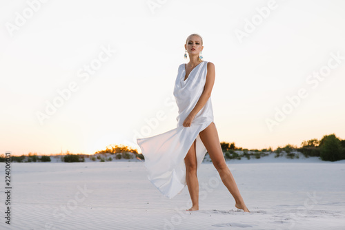 girl in a white tunic against the background of a night desert photo